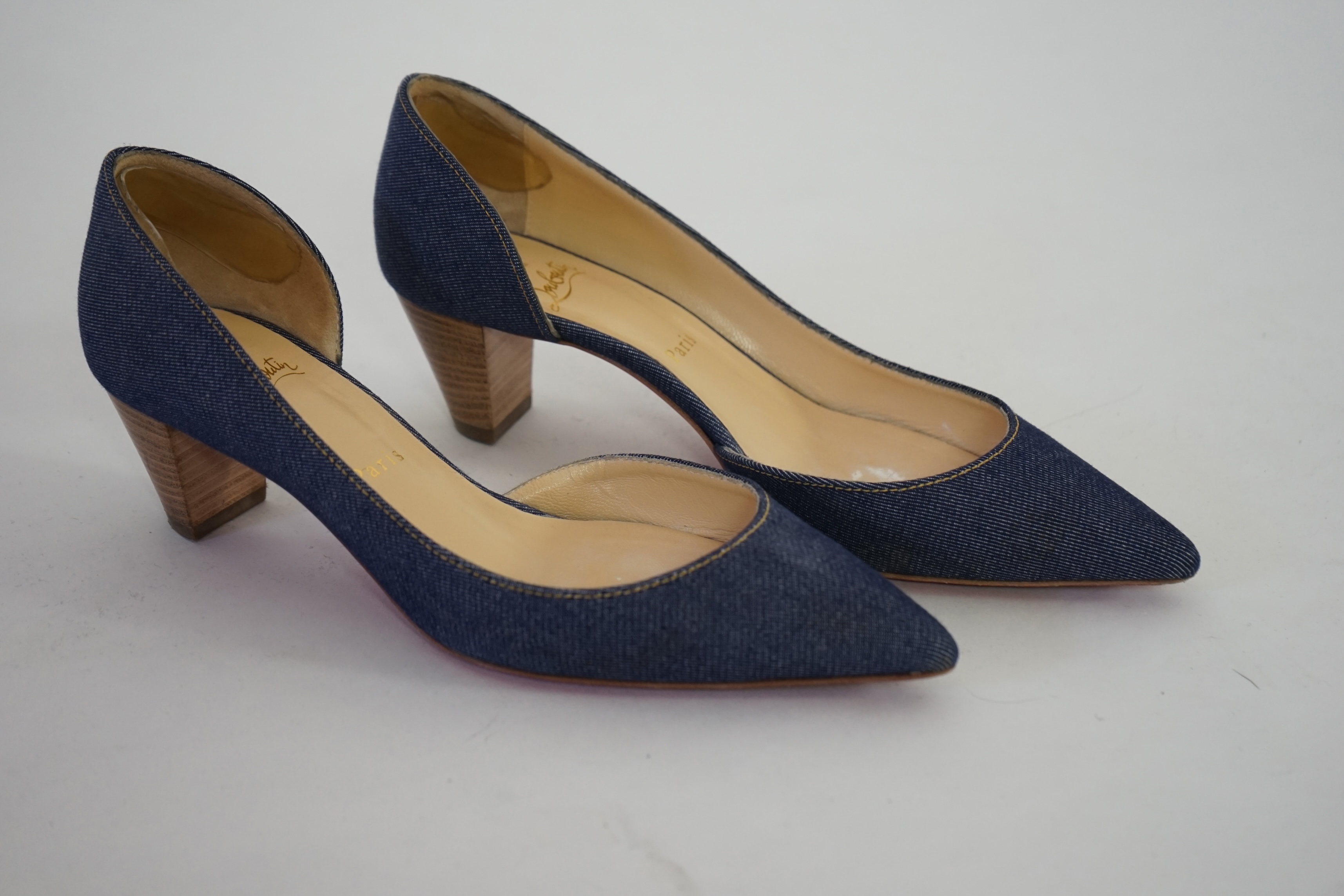 A pair of Christian Louboutin lady's denim pumps with wooden heels, comes with dust bag in original box. Size 39. Proceeds to Happy Paws Puppy Rescue